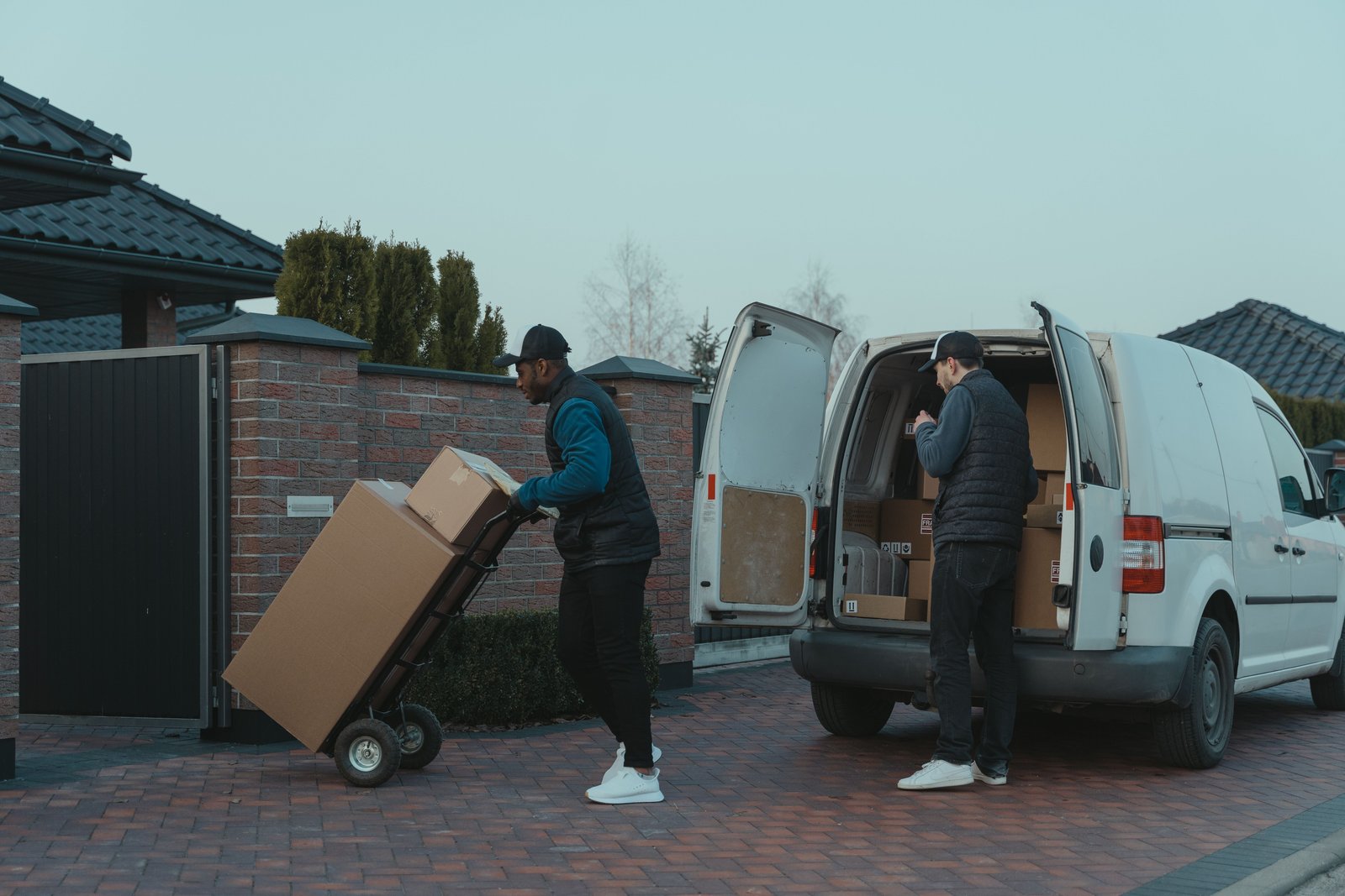 Delivery team handling packages by a van